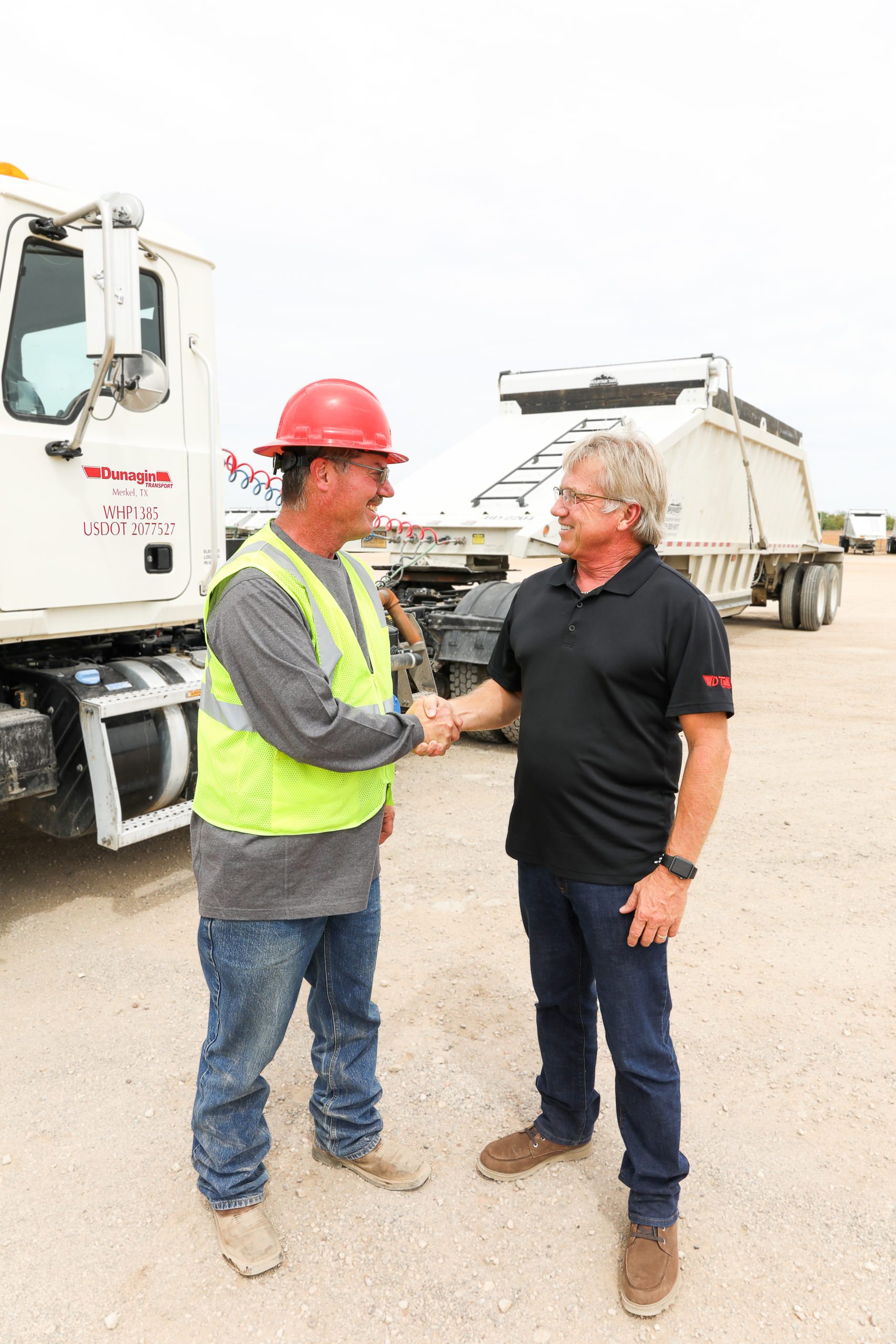 Belly Dump Driver, Michale Bryan, and VP of Operations, Mike Porter, shaking hands